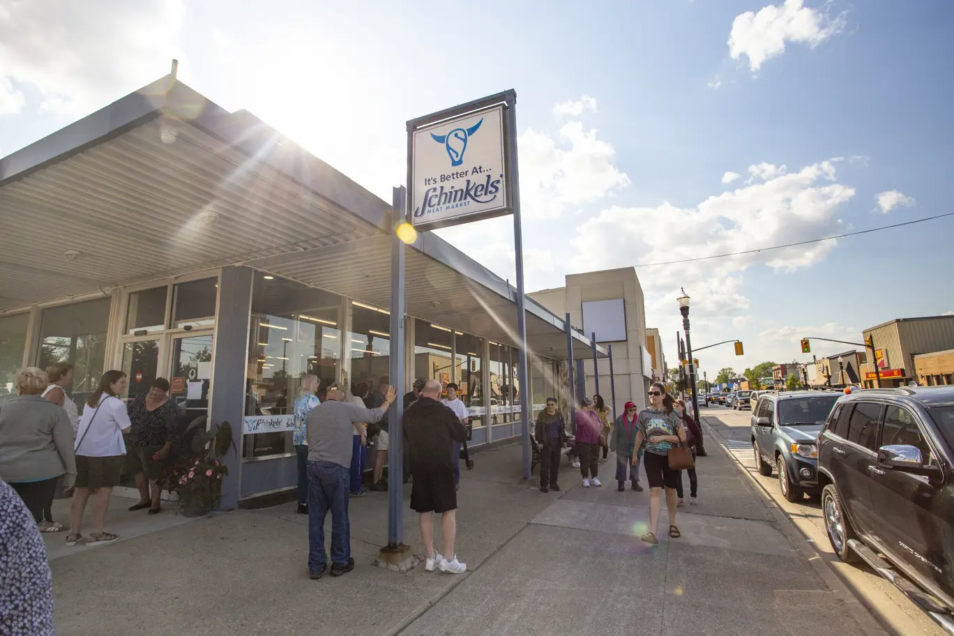 people standing outside storefront