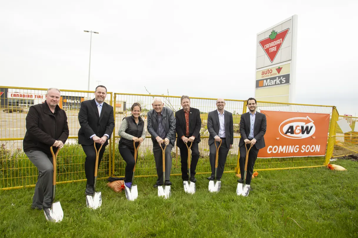 people standing with shovels in the ground