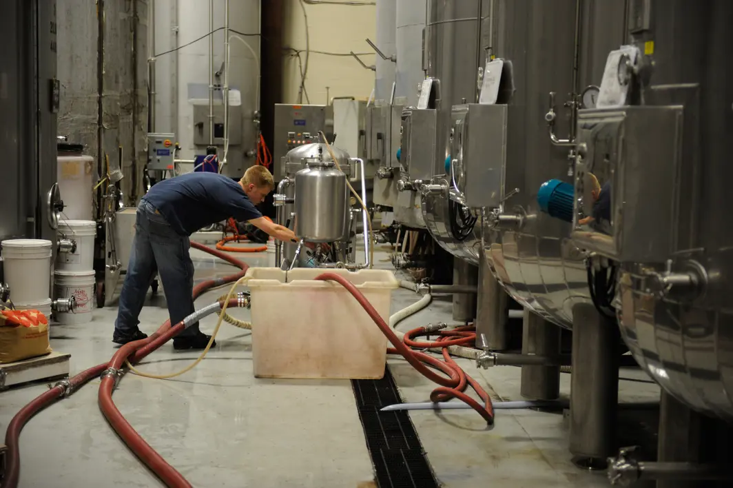 man cleaning water silos