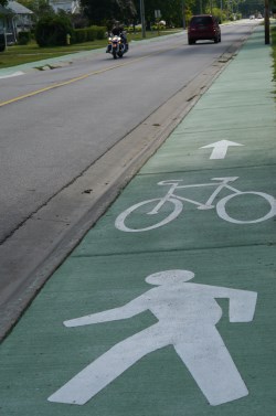 Cycling symbol on green path alongside road