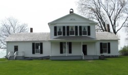White wooden home on lakeshore