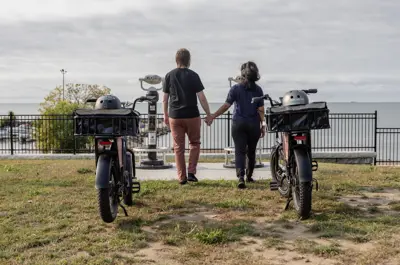 Two people looking out at Lake Erie with their Bikes