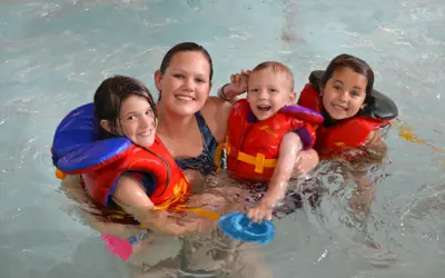 Kids swimming with an instructor