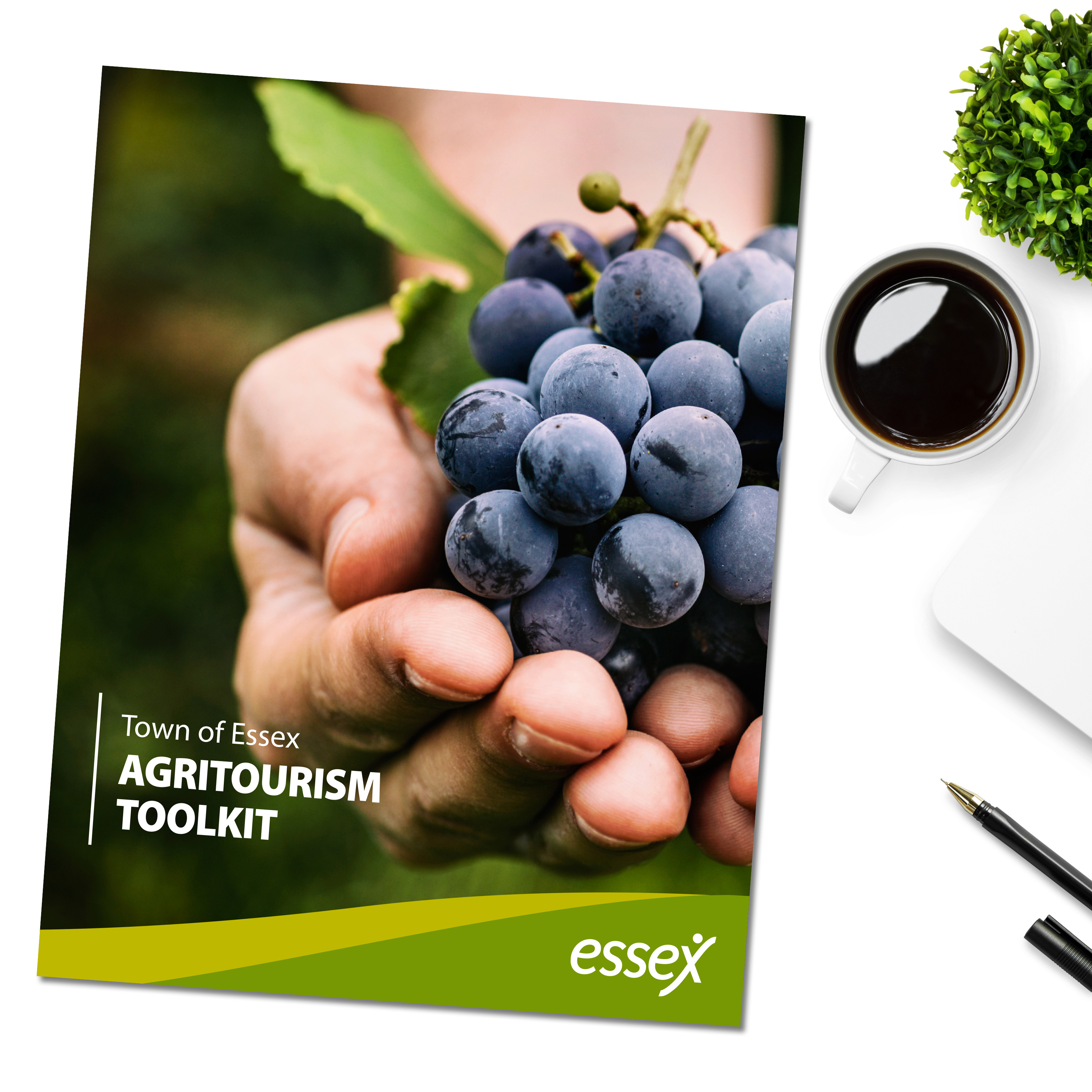 Agritourism Toolkit booklet on desktop with computer, coffee mug, and plant.