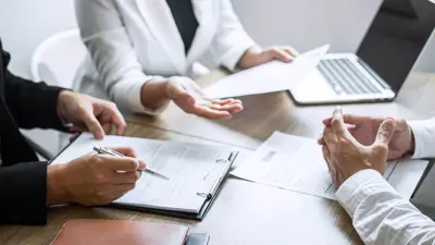Three people in a meeting