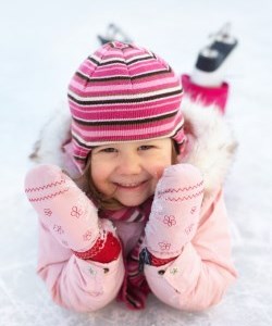 Girl in skates laying on ice