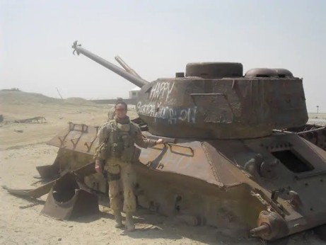 Photo of Catherine Wollocombe in front of Army Tank